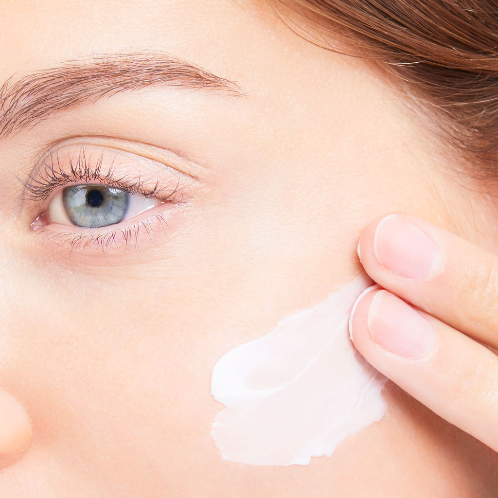 woman applying moisturizer