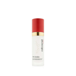 A bottle of Cellcosmet Ultra Sensitive Face Cream, featuring a white bottle with a vibrant red cap and a gold metallic collar, set against a plain white background.
