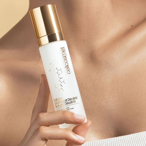 A woman presents a bottle of CellLift Neck and Decollete, highlighting her smooth neck and the product's elegance.