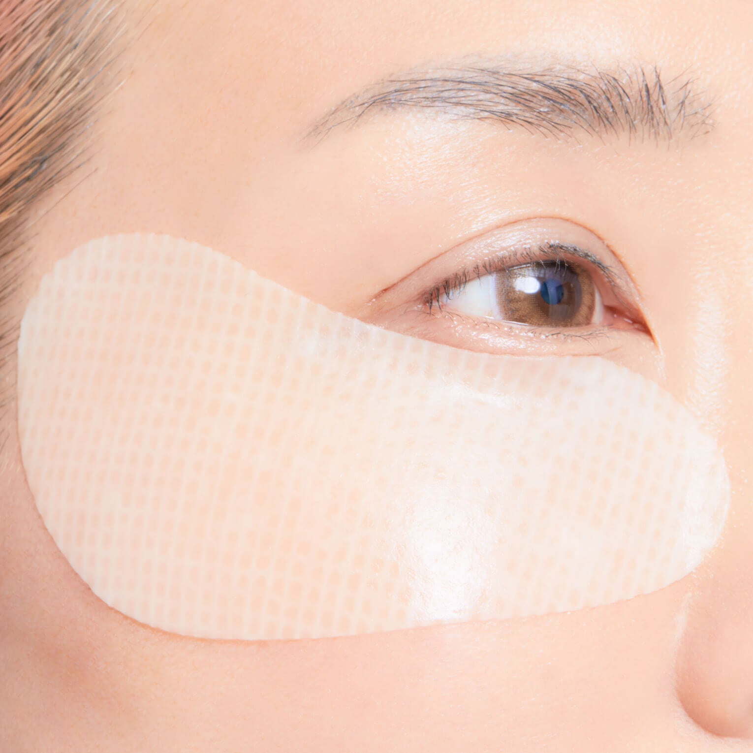 Close-up of a woman wearing eye patch on her face.