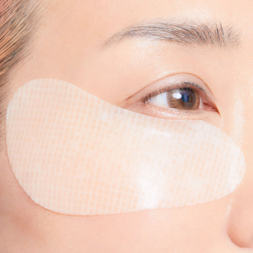 Close-up of a woman wearing eye patch on her face.