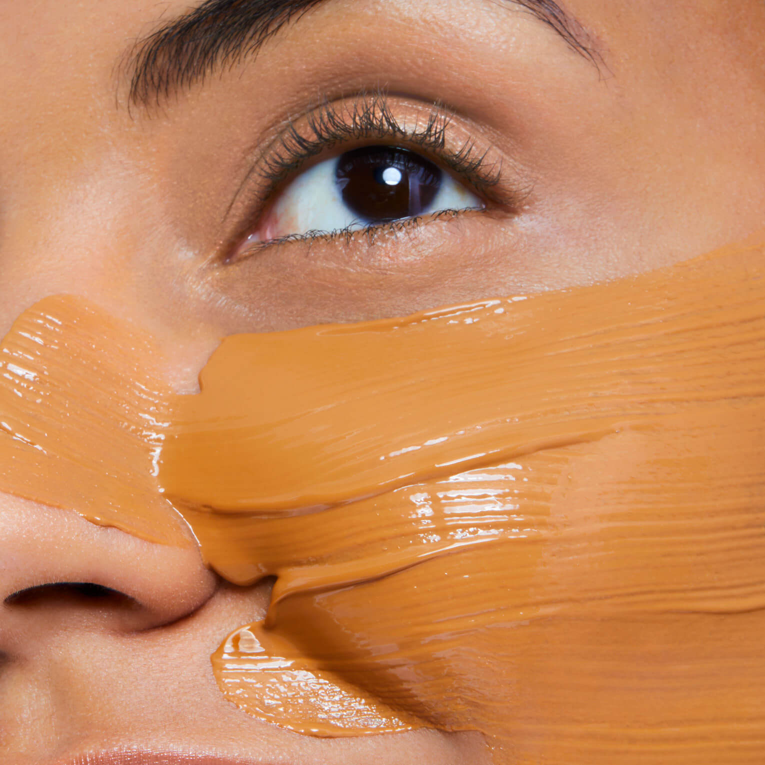 Close-up of a person's eye with brown mask applied to the face
