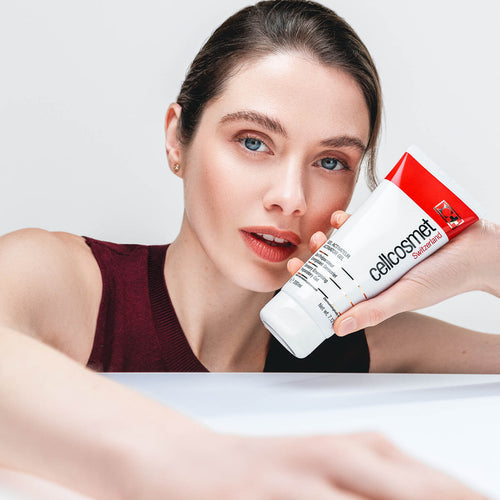 Woman holding Activator Gel to face