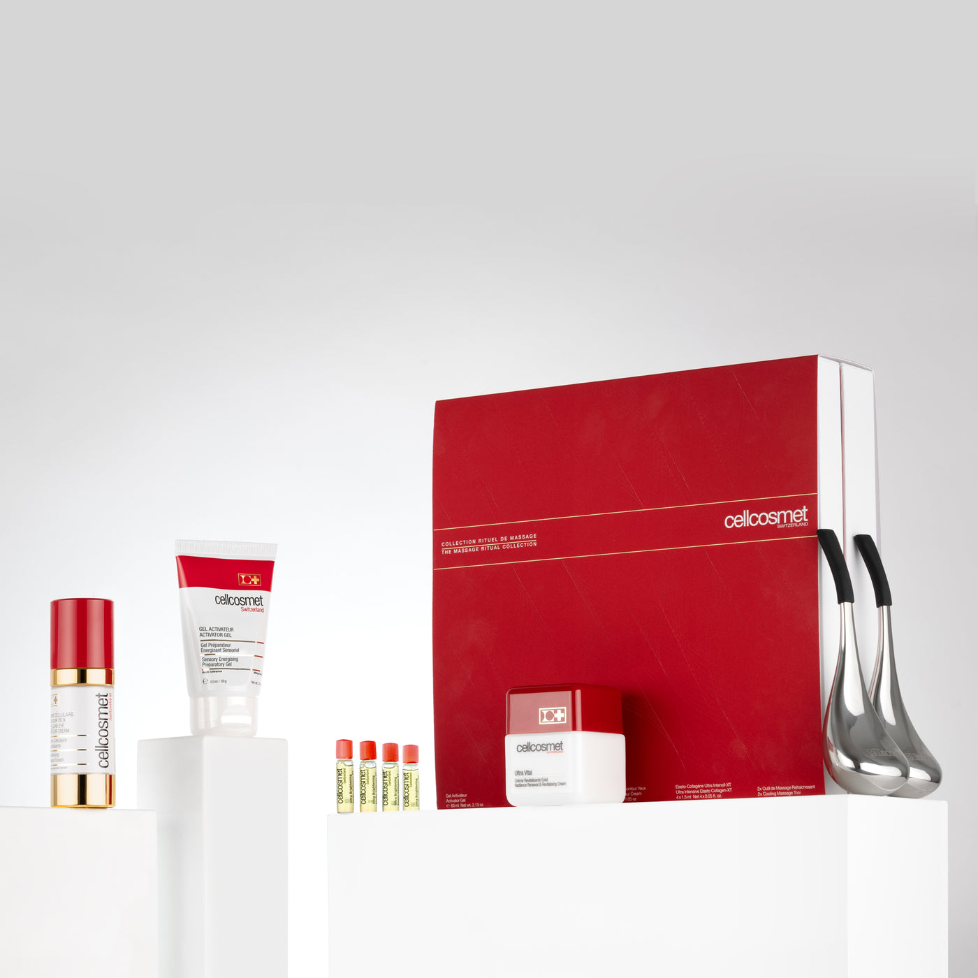 Sskincare products arranged on a white table, featuring creams and cryo-sticks for rejuvenation.