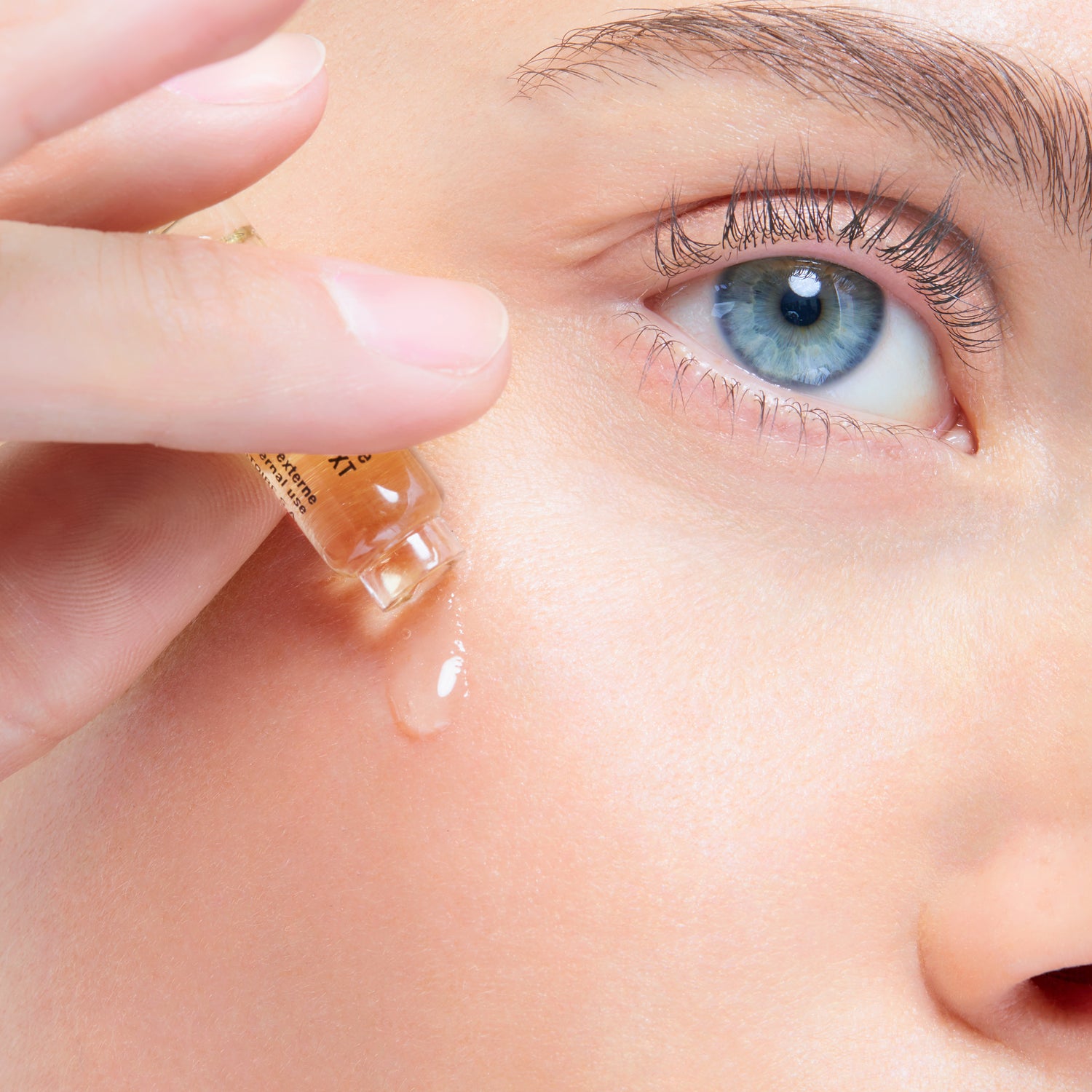 Woman applying Cellcosmet serum to face