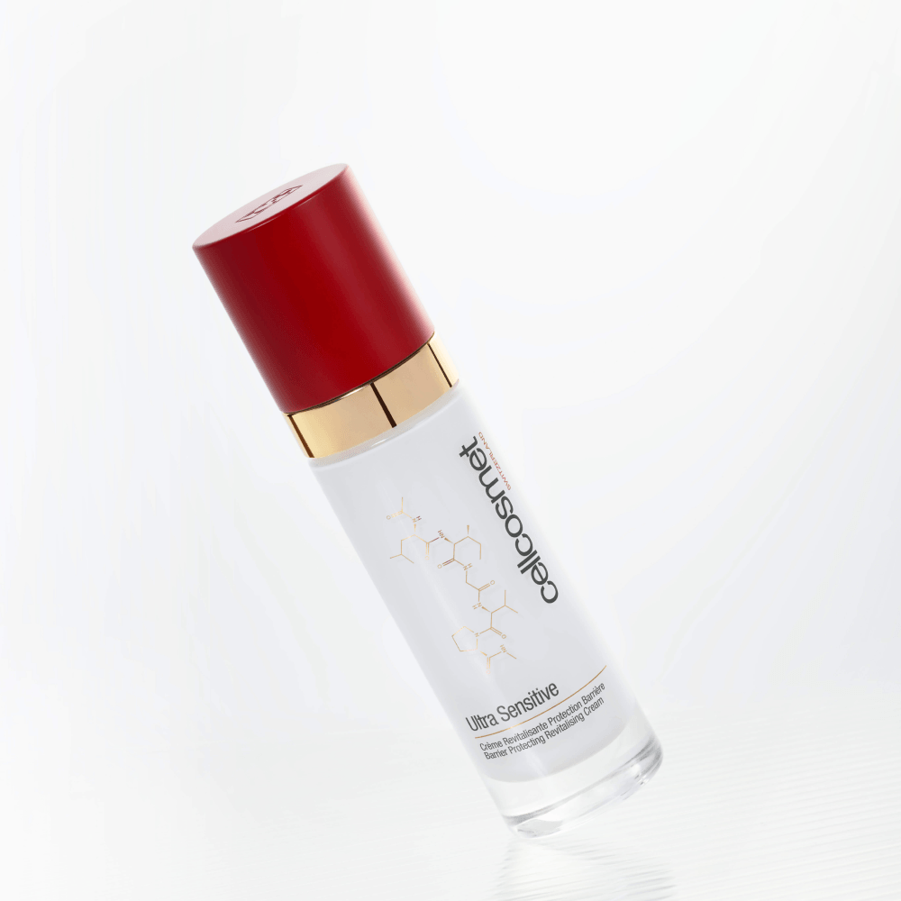 A bottle of Cellcosmet Ultra Sensitive Face Cream, featuring a white bottle with gold lettering and a glossy red cap, set against a clean white background.