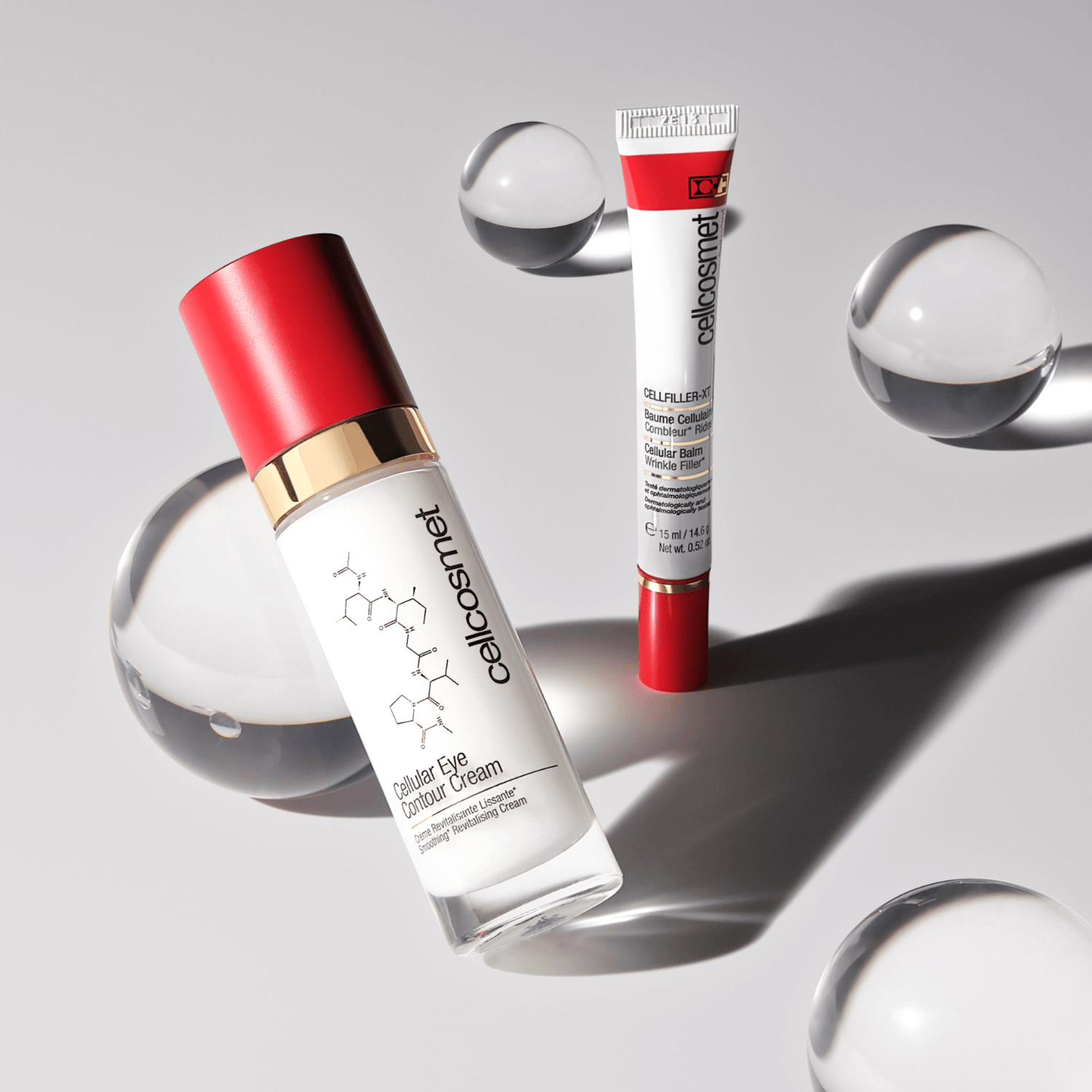 Cellcosmet skincare products with red and white packaging on a gray background