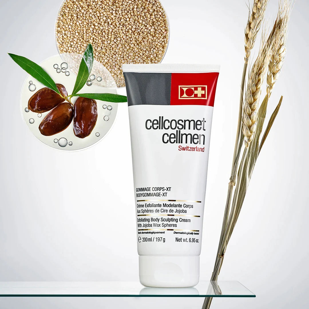 Cellcosmet Cellmen BodyGommage-XT 200 ml on a glass table with pictures of products such as wheat and organic quinoa extract used in it's key ingredients. Some of these key ingredients include SveltFermete Complex and Wheat Germ Oil.