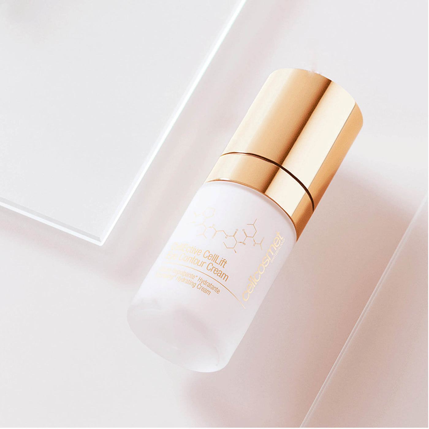 Skincare bottle of CellLift Eye Contour Cream with gold cap on a light pink background