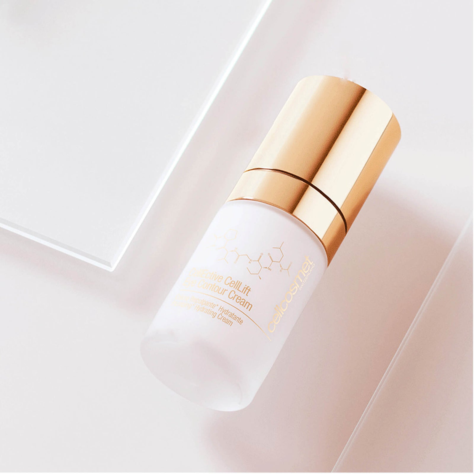 Skincare bottle of CellLift Eye Contour Cream with gold cap on a light pink background