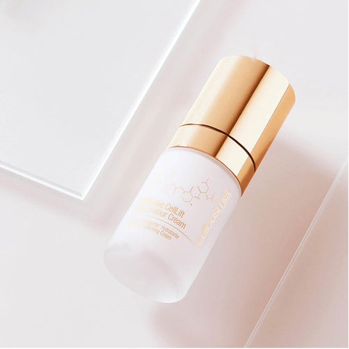 Skincare bottle of CellLift Eye Contour Cream with gold cap on a light pink background