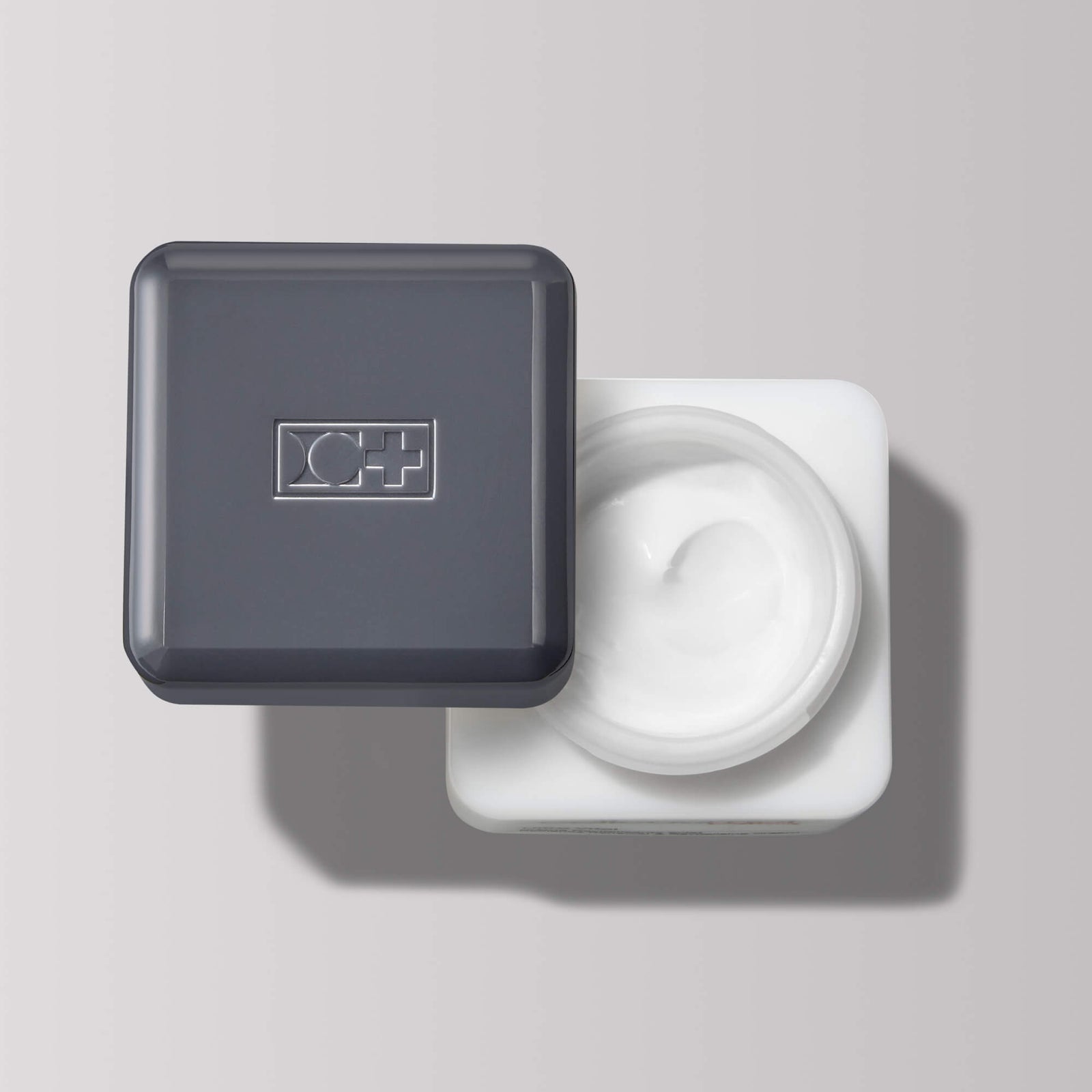 Jar of cellmen face cream with a gray lid on a light gray background