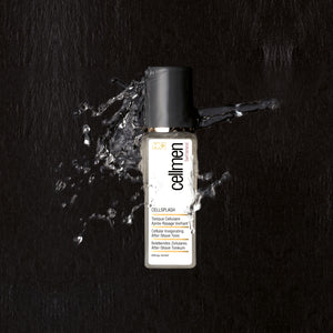 A bottle of Cellmen Cellsplash skin care product on a black surface, surrounded by splashes of water for a refreshing effect.