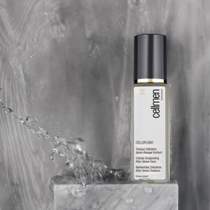 A bottle of Cellmen CellSplash on a marble surface, surrounded by splashes of water, highlighting its refreshing appeal.