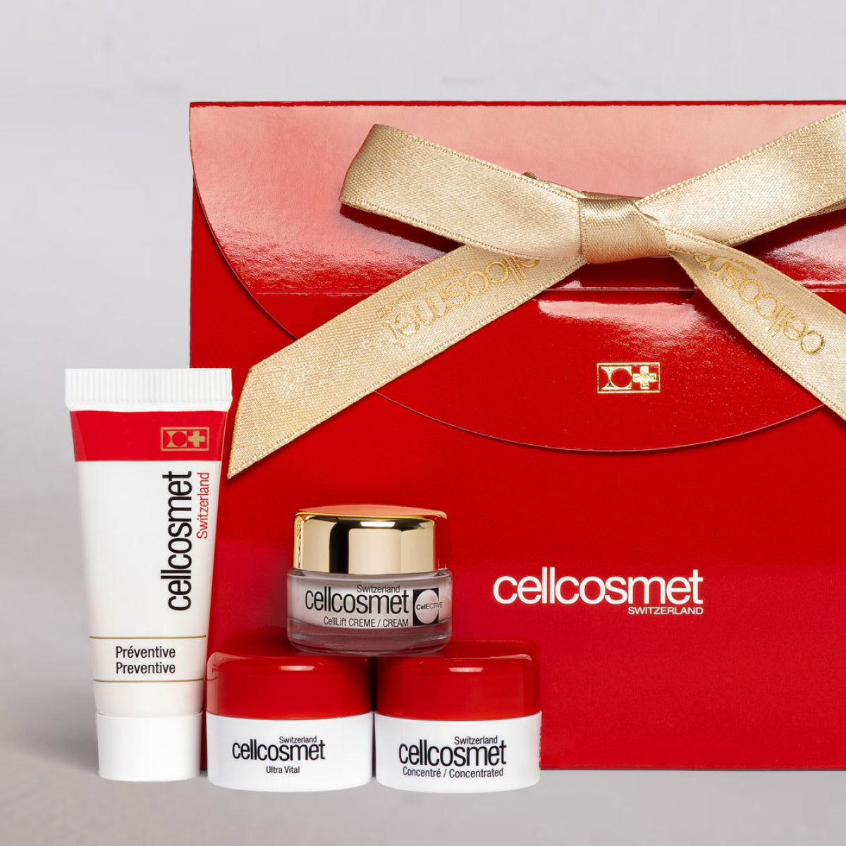 Cosmetic set with red and gold packaging featuring the 'cellicosmet' brand.