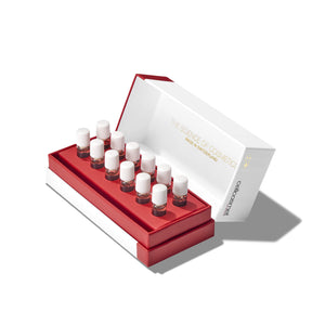 Set of small bottles with white caps in a red and white box on a white background of Ultra Brightening Elasto-Collagen-XT
