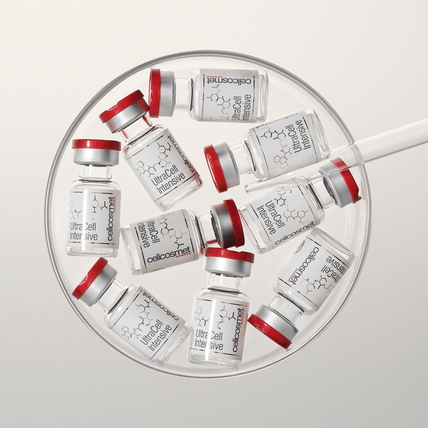 Collection of ultracell intensive vials arranged in a circular pattern on a light gray background.