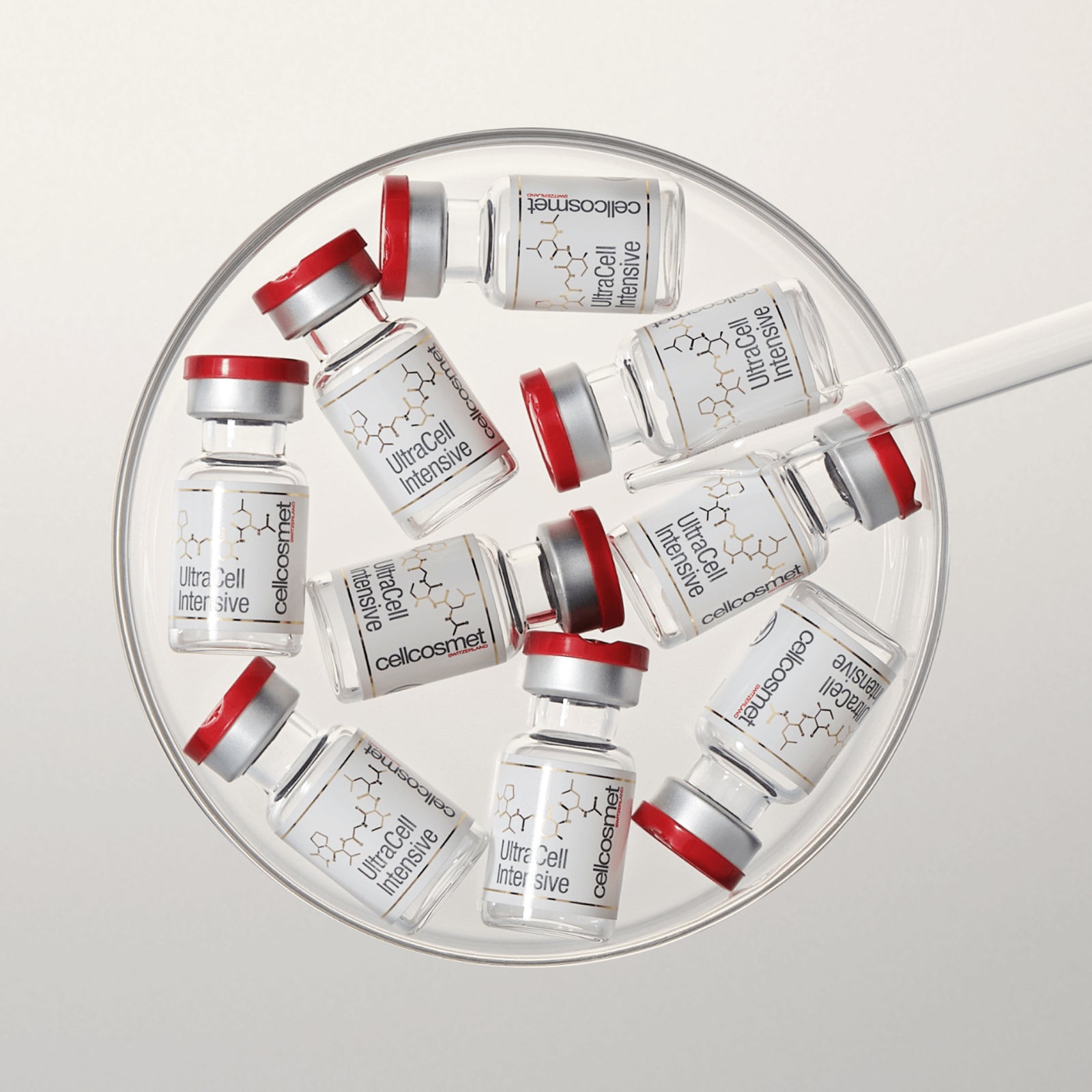 Collection of ultracell intensive vials arranged in a circular pattern on a light gray background.