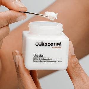 Cellcosmet ultra vital cream jar with a hand applying cream using a brush.