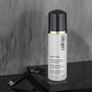 A marble countertop in the bathrooom with a razor in the background highlights the Cellmen Wash N' Shave 150ml product.